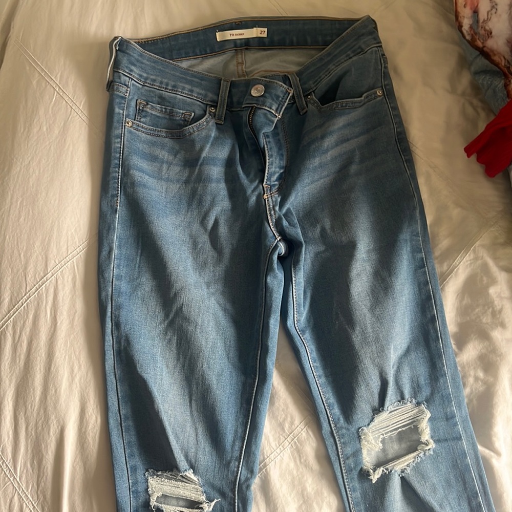 LEVIS size women’s 27 skinny jeans from levi blue wash with rips at the knees